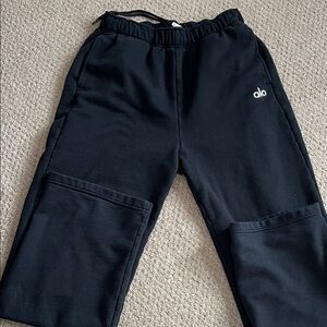 ALO Yoga black crewneck sweatshirt and straight leg sweat pants.